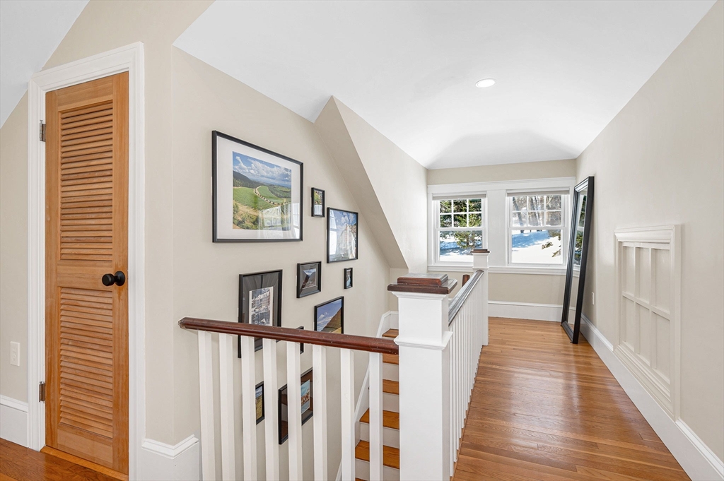 430 West Street Reading, MA 01867 - Photo 21 of 35 a view of a hallway with wooden floor and staircase