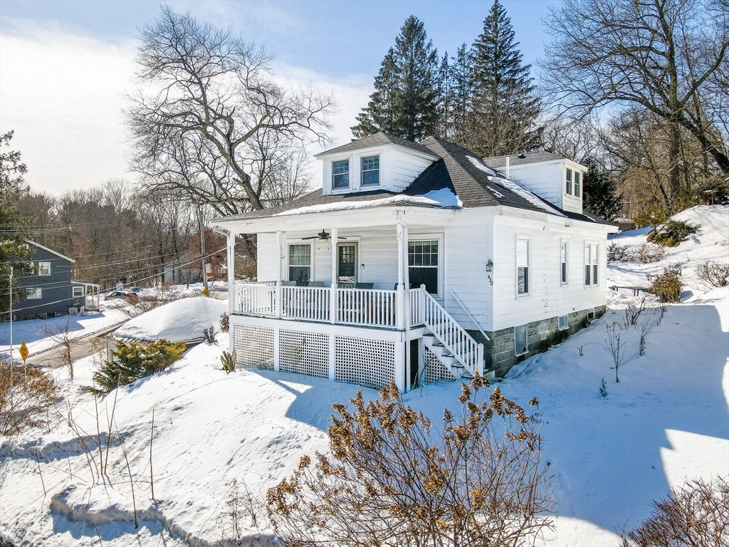 430 West Street Reading, MA 01867 - Photo 25 of 35 a view of a white house with a yard covered in snow