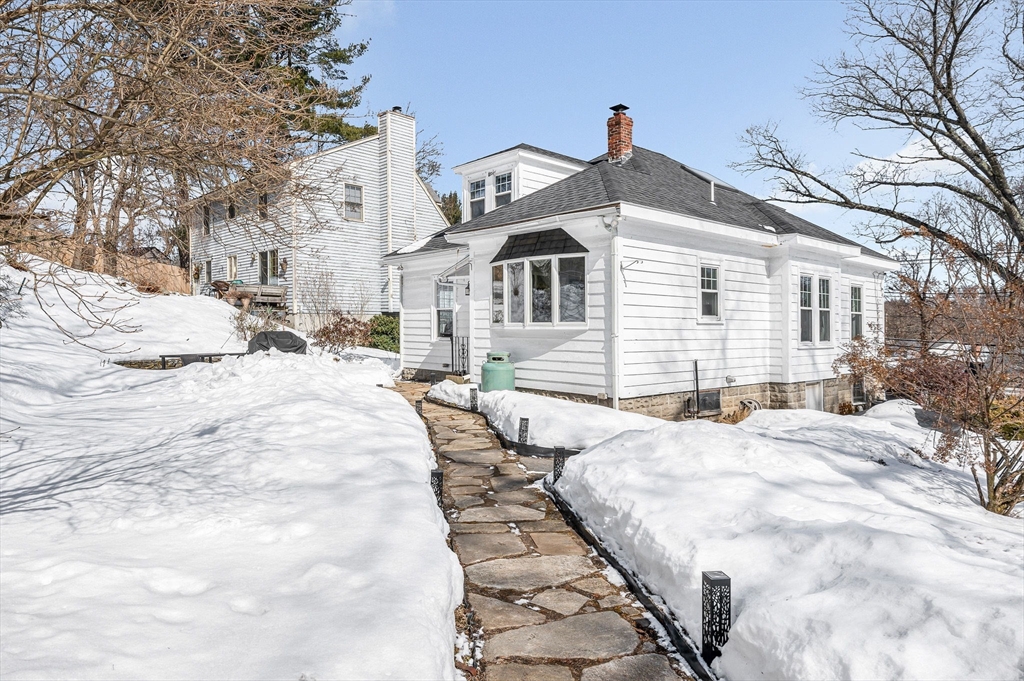 430 West Street Reading, MA 01867 - Photo 26 of 35 a view of a white house with a yard covered in snow