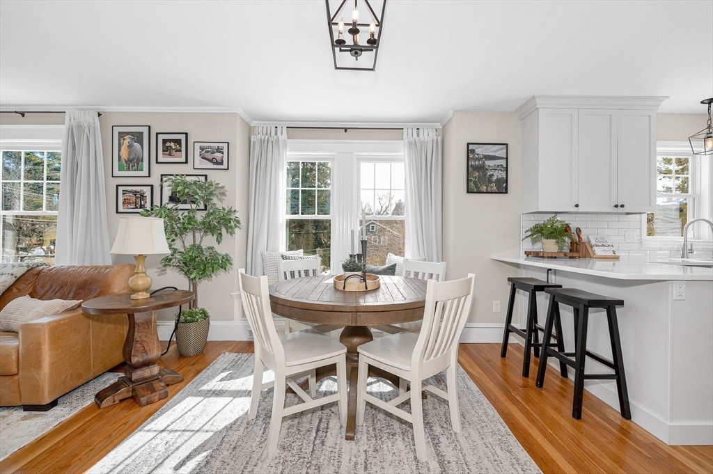 430 West Street Reading, MA 01867 - Photo 7 of 35 a view of a dining room with furniture a couch and wooden floor