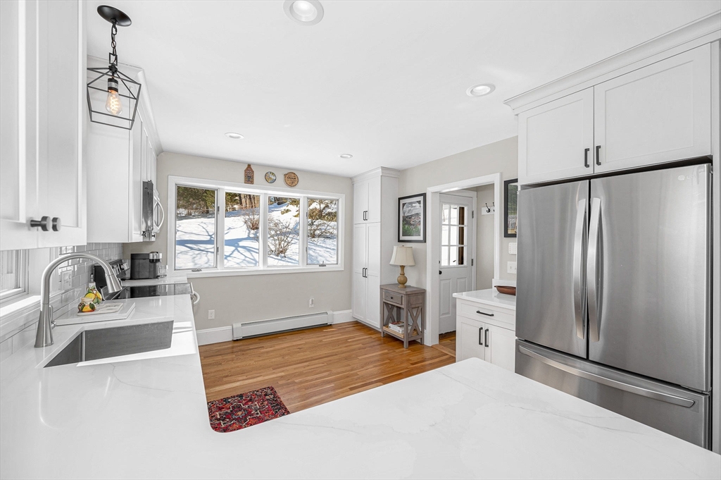 430 West Street Reading, MA 01867 - Photo 9 of 35 a kitchen with stainless steel appliances granite countertop a refrigerator and a sink