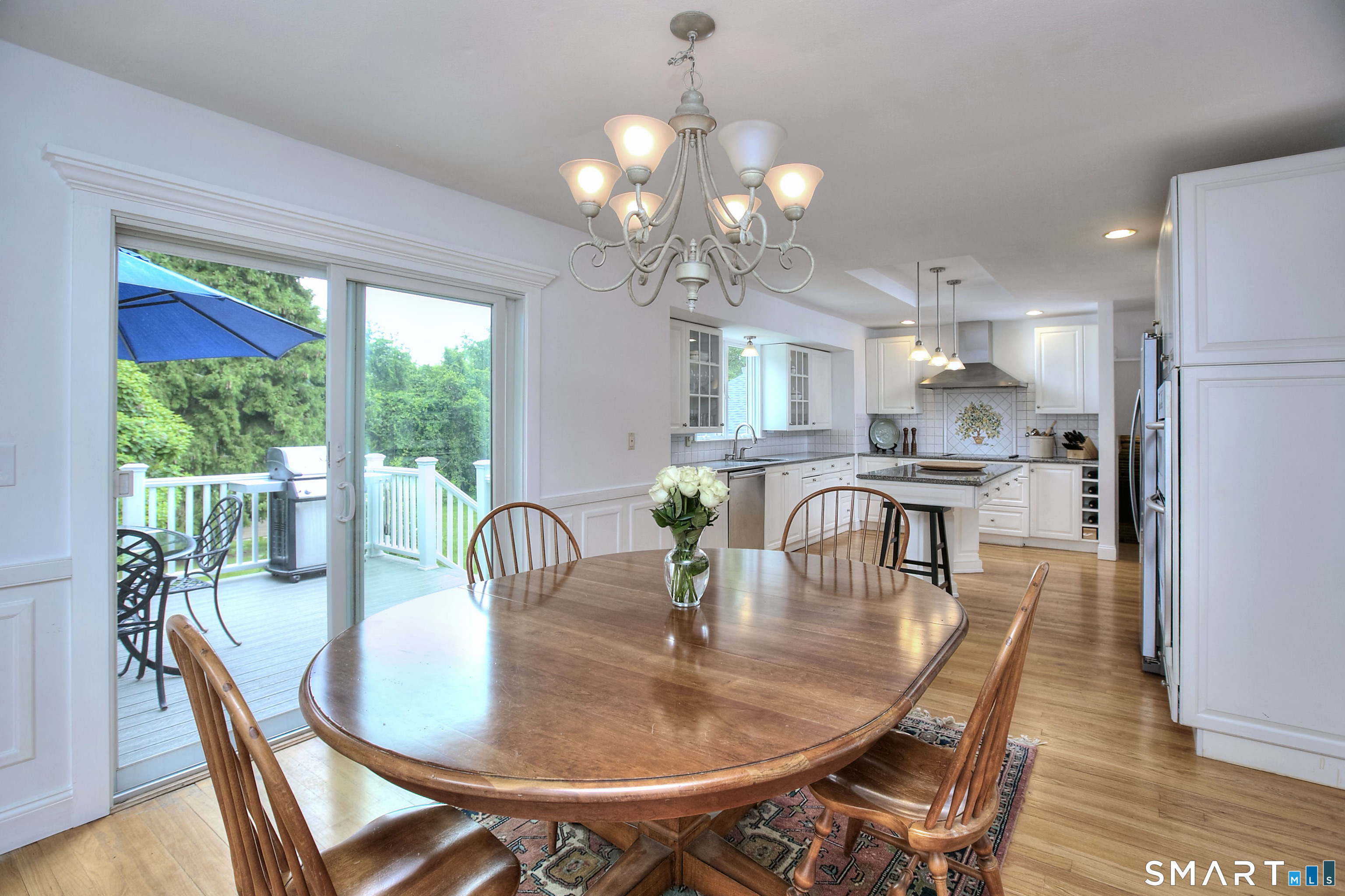 324 Ridge Road Orange, CT 06477 - Photo 6 of 38 a dining room with furniture a large window and wooden floor
