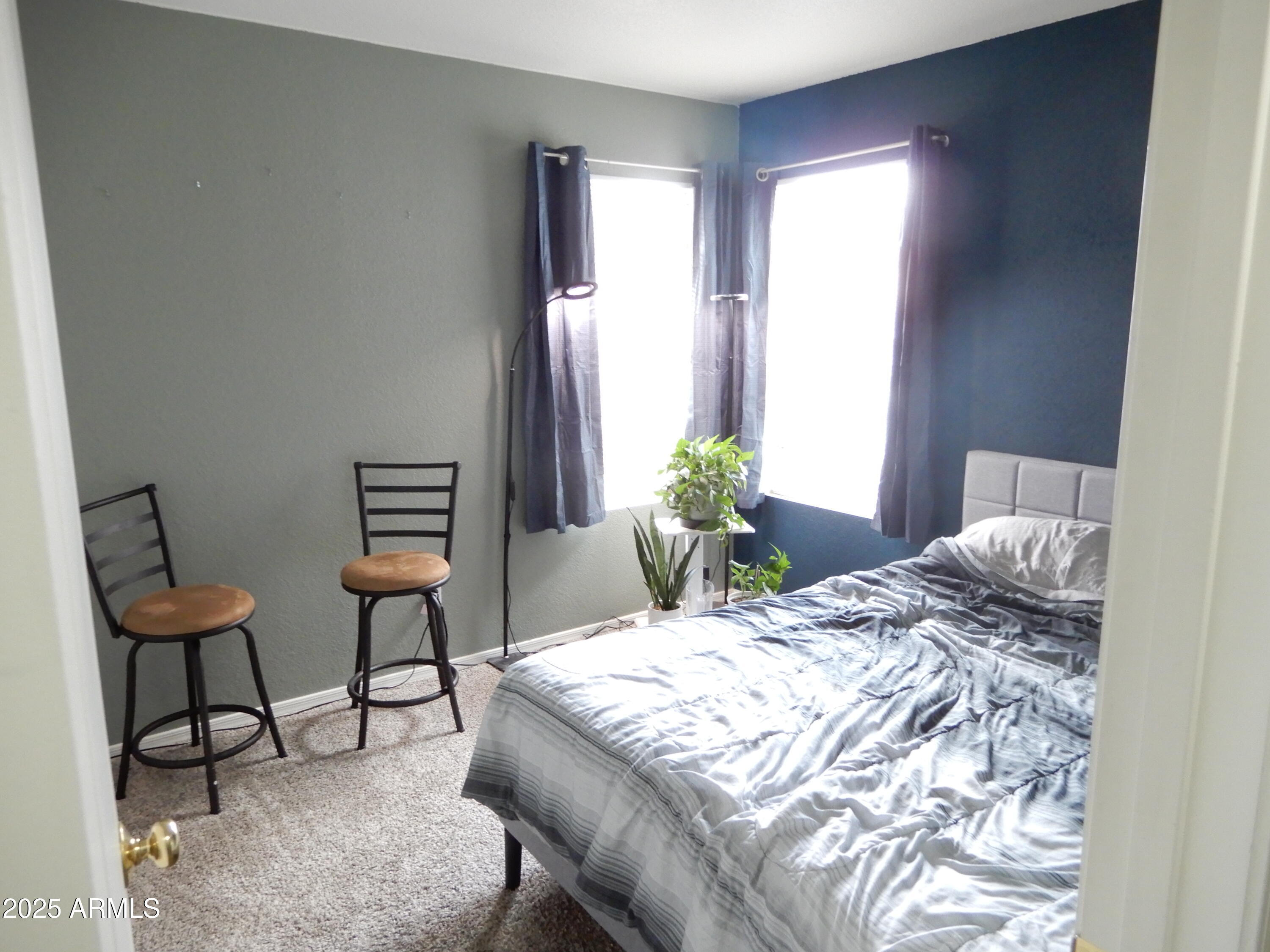 3436 South Chaparral Road Apache Junction, AZ 85119 - Photo 11 of 28 a bedroom with a bed and a chair