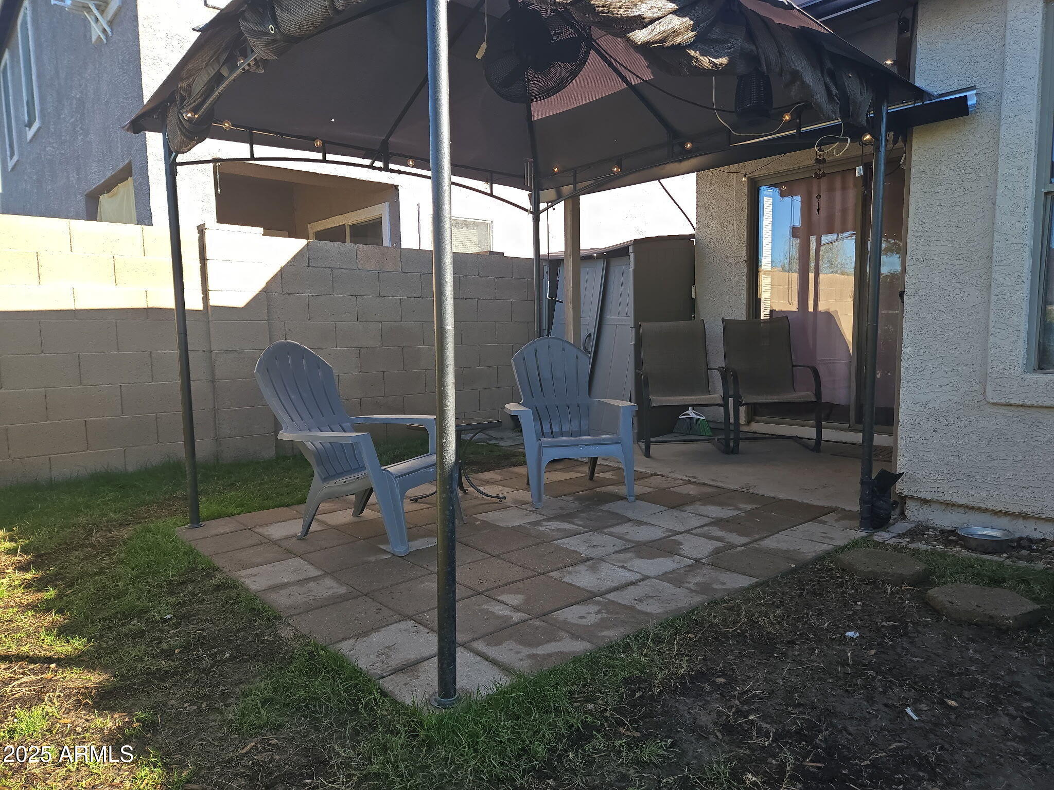 3436 South Chaparral Road Apache Junction, AZ 85119 - Photo 20 of 28 a view of backyard with a table and chairs under an umbrella