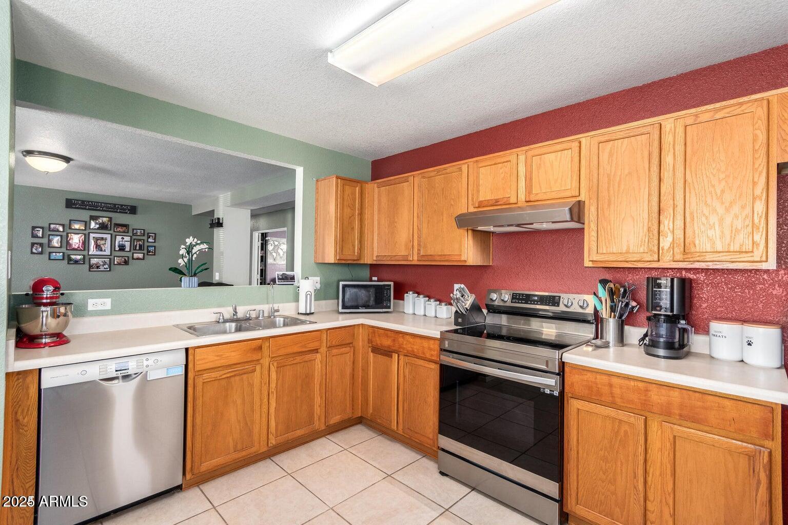 3436 South Chaparral Road Apache Junction, AZ 85119 - Photo 6 of 28 a kitchen with a sink stove top oven and cabinets