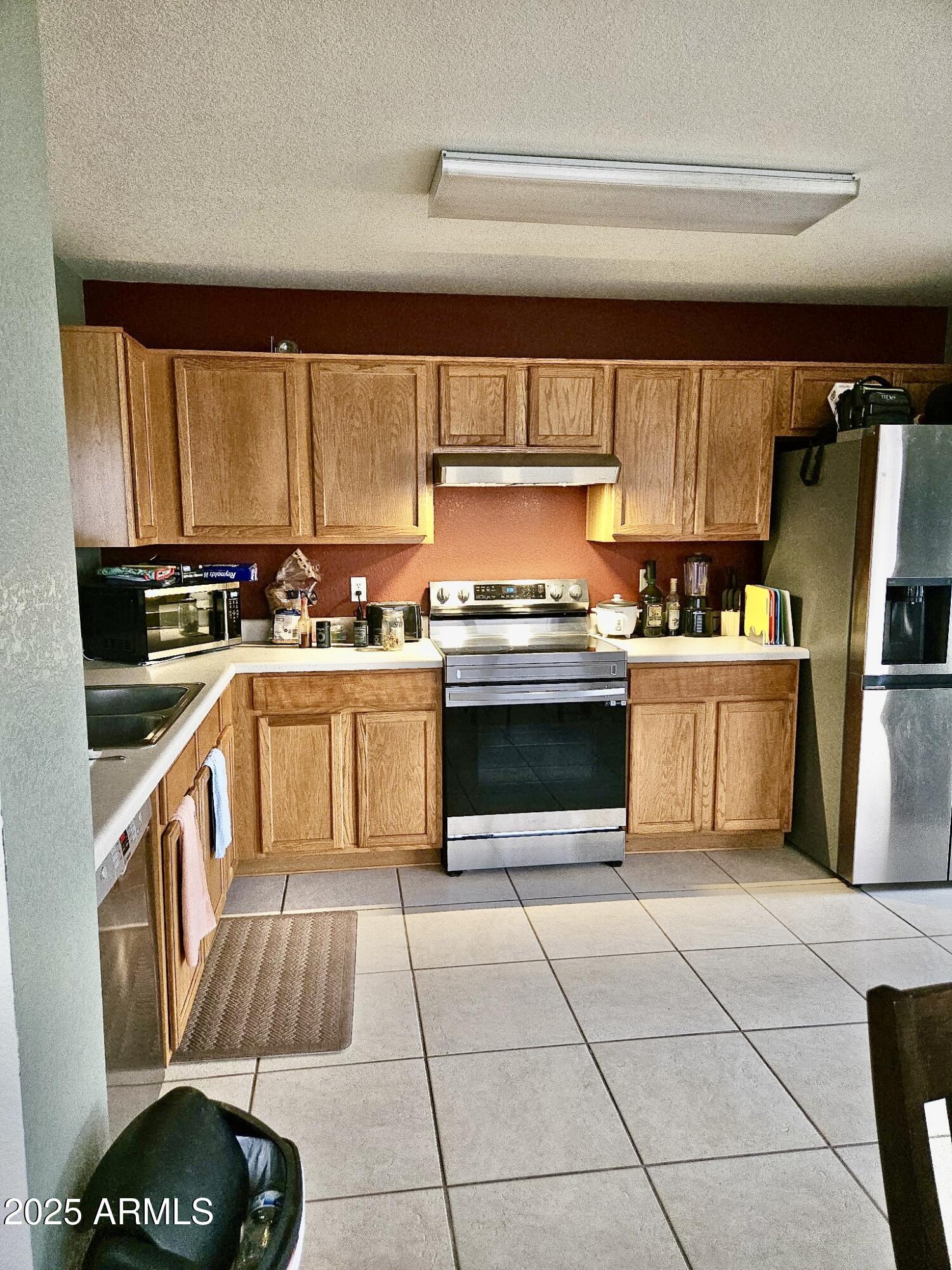 3436 South Chaparral Road Apache Junction, AZ 85119 - Photo 8 of 28 a kitchen with a sink a stove a refrigerator and cabinets
