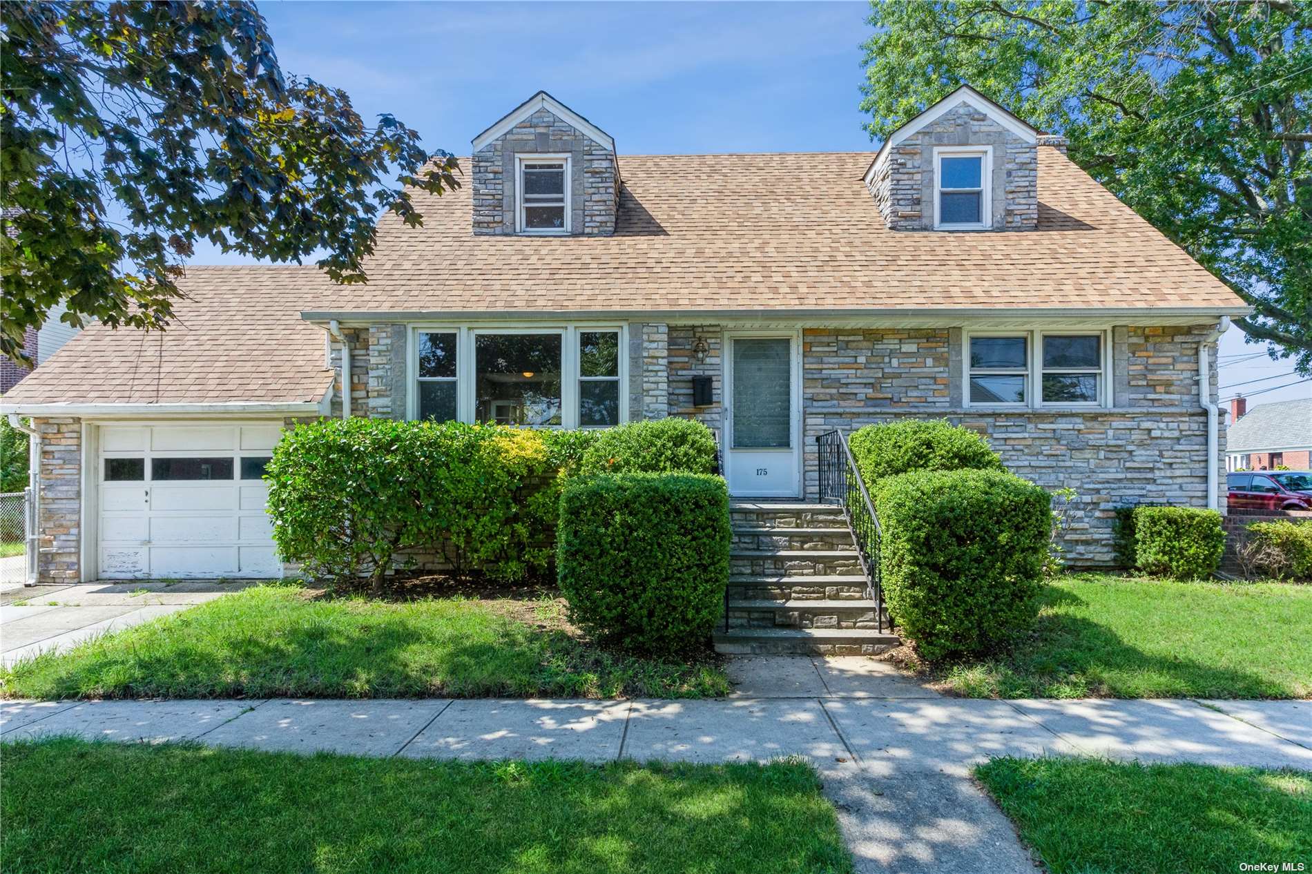 175 Roxbury Road South Garden City, NY 11530 - Photo 1 of 1 a view of a house with a yard and plants