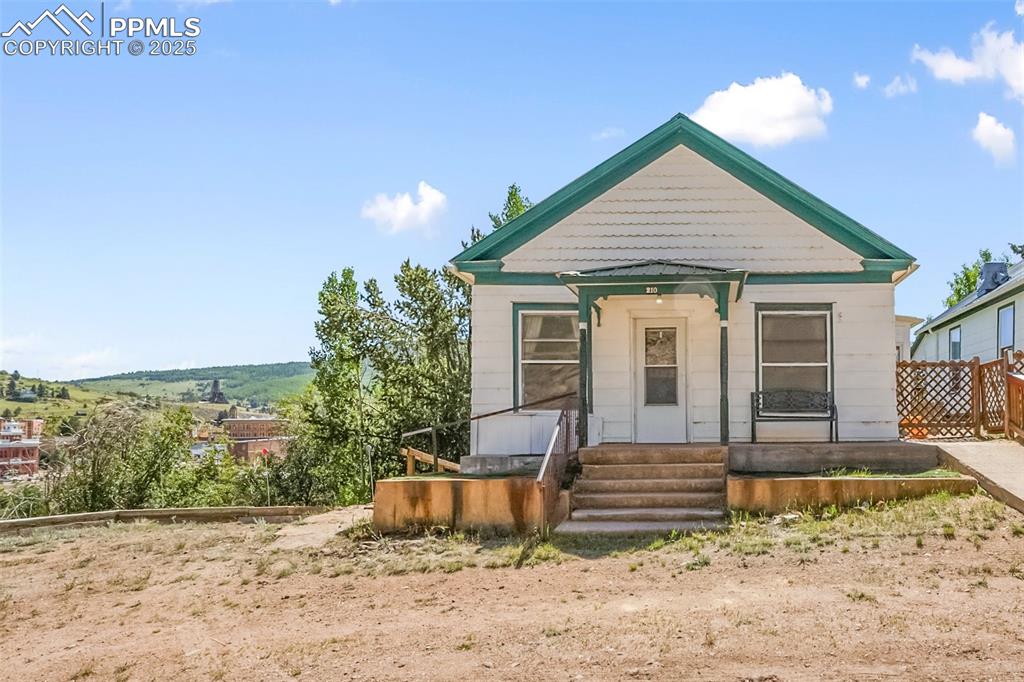 210 7th Street Victor, CO 80860 - Photo 1 of 38 a front view of a house with garden