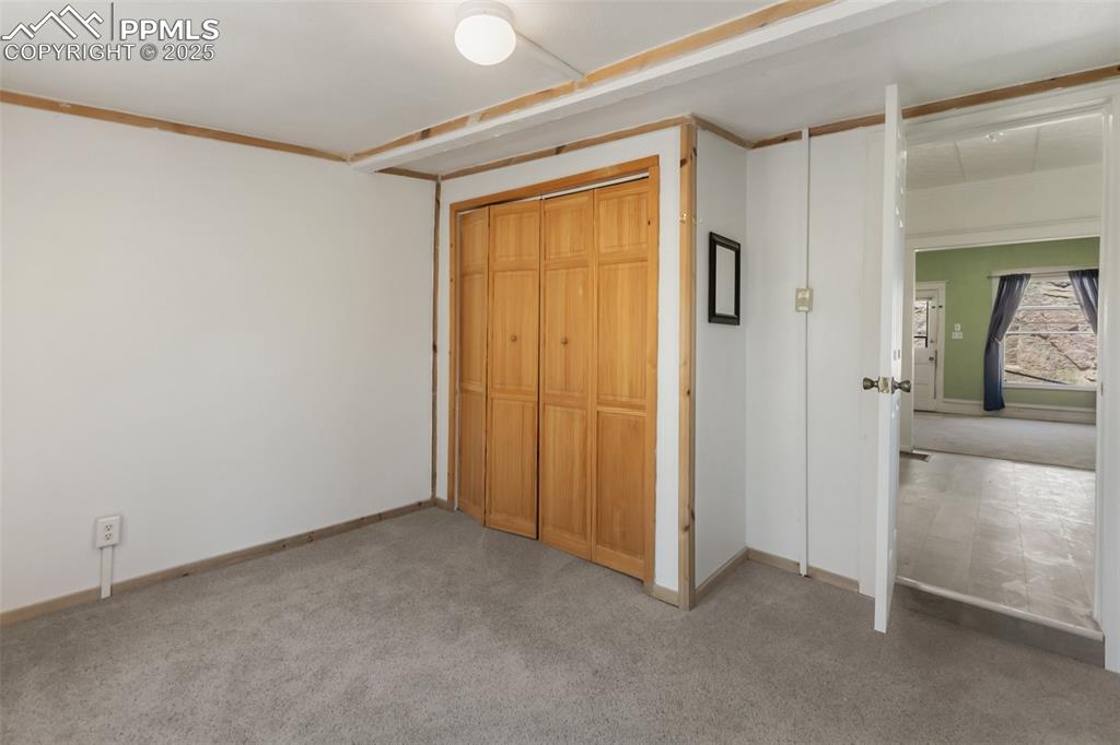 210 7th Street Victor, CO 80860 - Photo 12 of 38 an empty room that has a wooden cupboard
