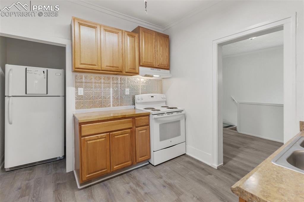 210 7th Street Victor, CO 80860 - Photo 20 of 38 a kitchen with a white stove top oven and refrigerator