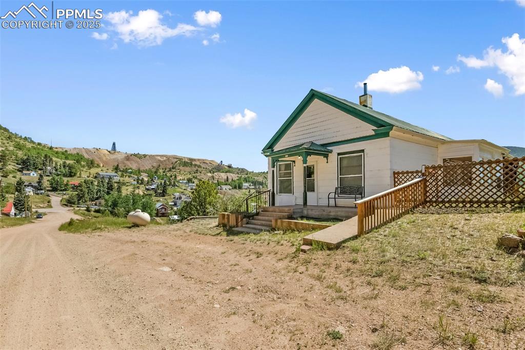 210 7th Street Victor, CO 80860 - Photo 2 of 38 a view of a house with a backyard and mountain view