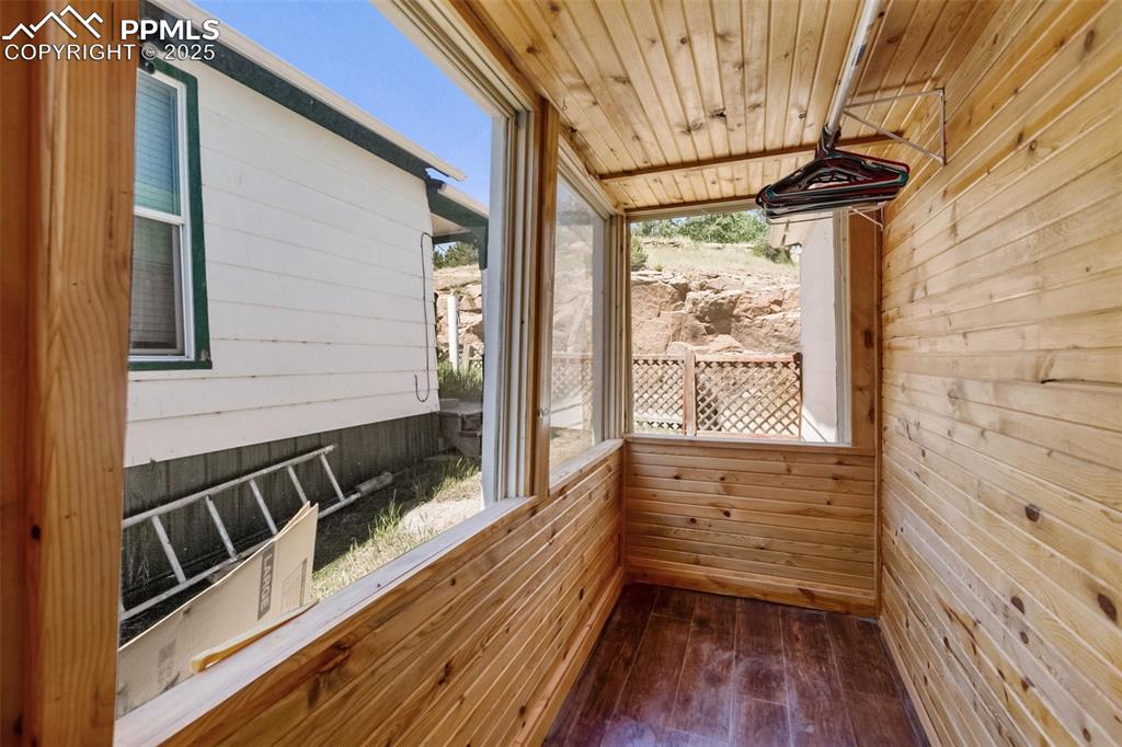 210 7th Street Victor, CO 80860 - Photo 27 of 38 a view of a balcony with wooden floor and iron gate