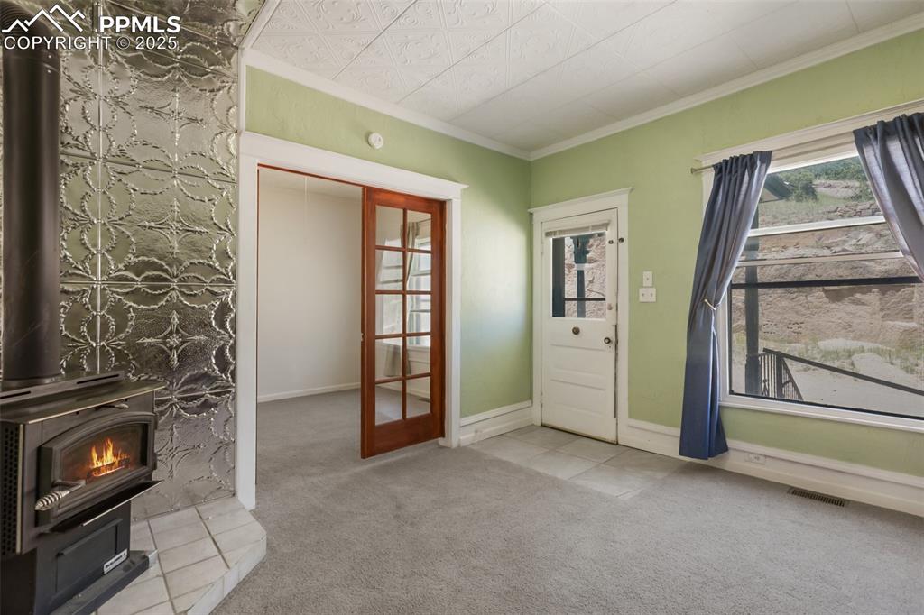 210 7th Street Victor, CO 80860 - Photo 10 of 38 a view of an empty room with a fireplace