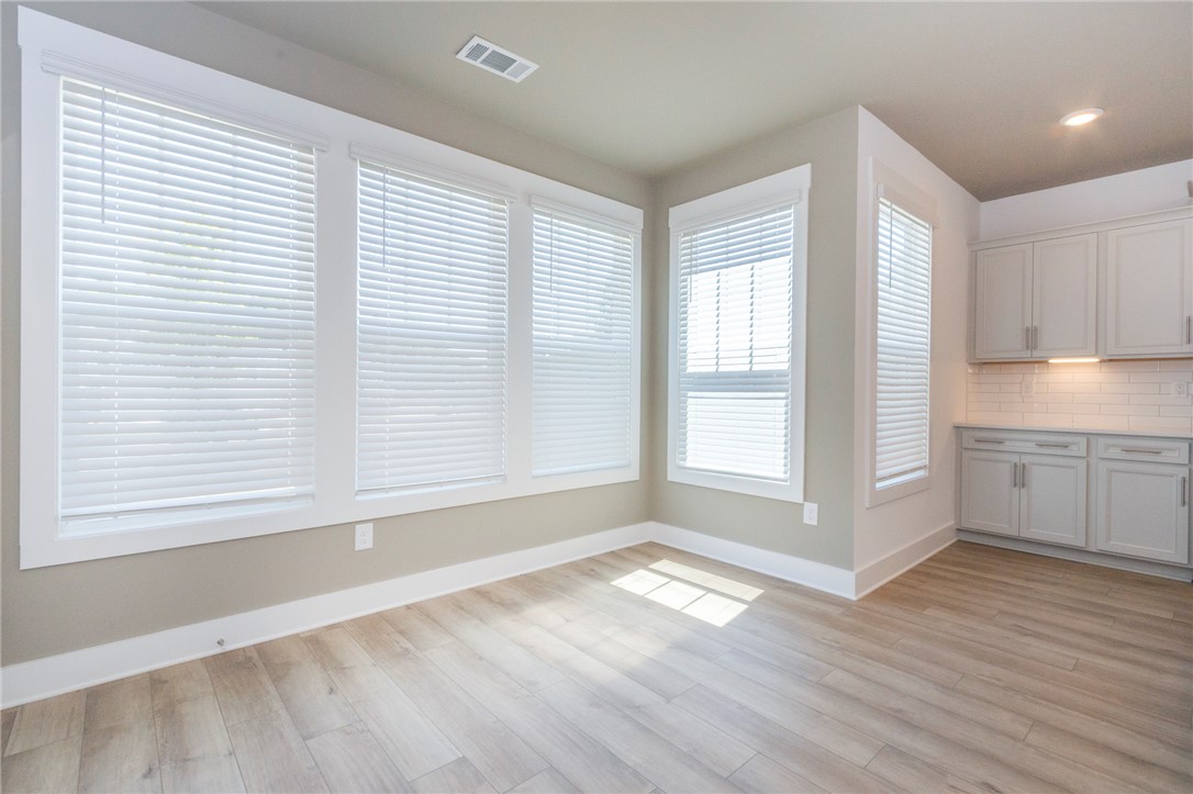 607 WH Kay Lane Anderson, SC 29621 - Photo 7 of 48 Sun-filled room boasts light wood flooring and a built-in kitchen cabinet area.