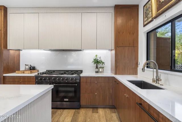 a kitchen with granite countertop a stove sink and cabinets