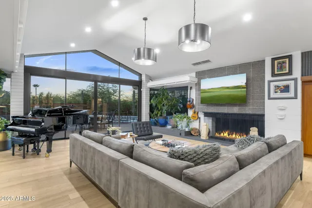 a living room with fireplace furniture and a flat screen tv