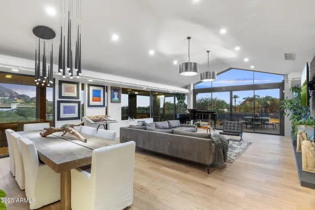 a living room with fireplace furniture and a large window