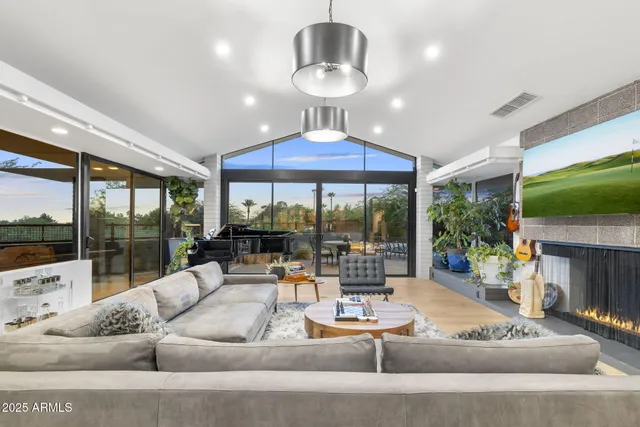 a living room with patio furniture and a fireplace