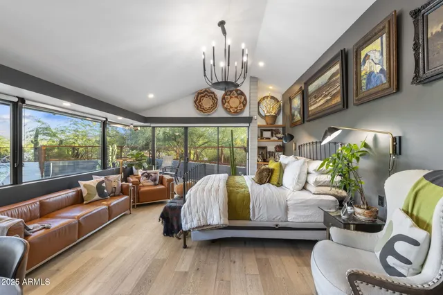 a bedroom with furniture and a large window