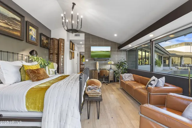 a bed room with furniture and a chandelier