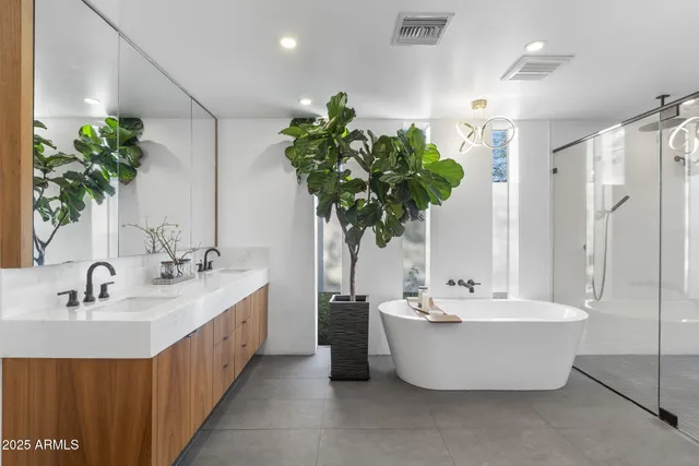 a bathroom with a double vanity sink and a bathtub