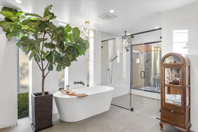 a living room with fireplace furniture and a potted plant