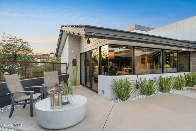 a view of a chair and tables in patio of the house