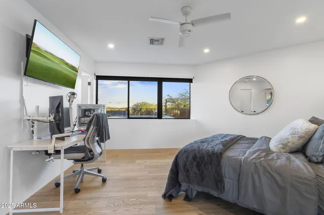 a bedroom with a bed a window and gym equipment