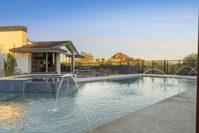 a view of a swimming pool with an outdoor seating