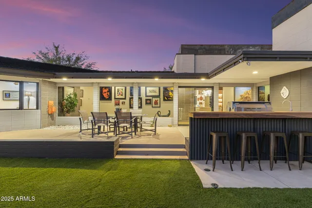 a view of a house with swimming pool and sitting area