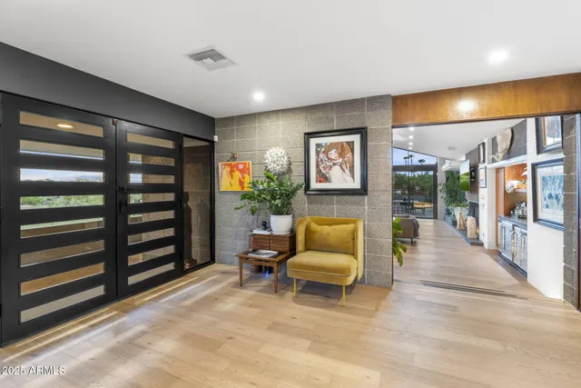 a living room with furniture and a potted plant