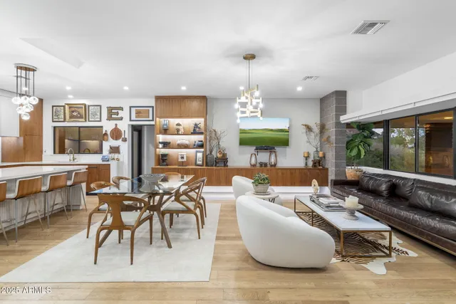 a living room with furniture a rug and a large window