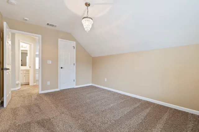 a bathroom with a granite countertop toilet sink and mirror