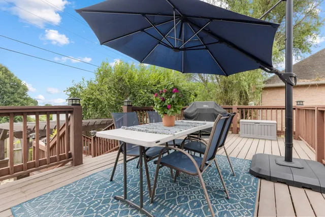 a backyard of a house with table and chairs