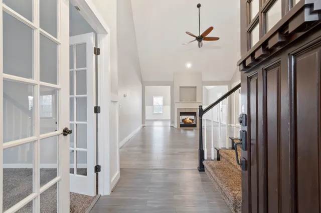 a view of a hallway with wooden floor and staircase