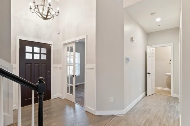 a view of a hallway with wooden floor and stairs