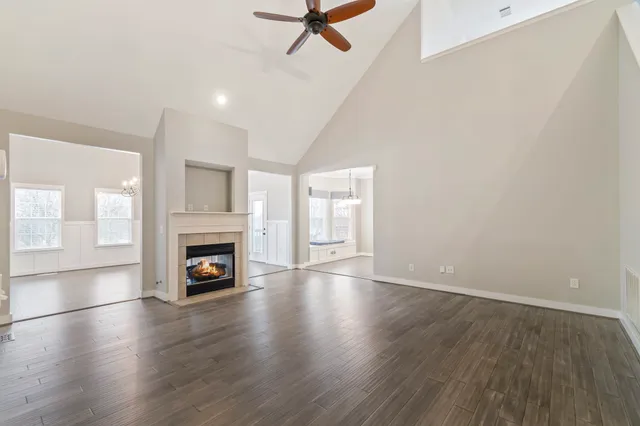 a view of an empty room with a fireplace and a window