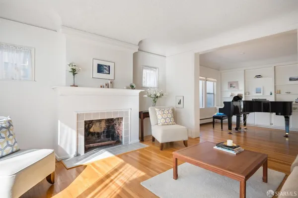 a living room with furniture and a fireplace