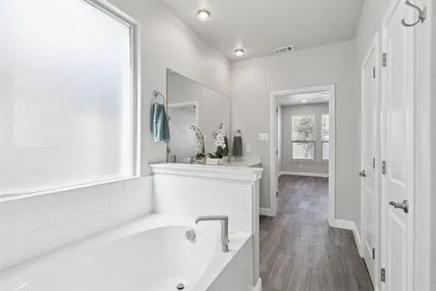 a bathroom with a bathtub and a sink