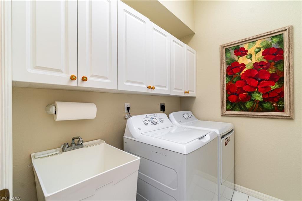 10274 Cape Roman Road, Unit 102 Estero, FL 34135 - Photo 21 of 36 a utility room with dryer and washer