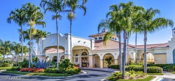 10274 Cape Roman Road, Unit 102 Estero, FL 34135 - Photo 30 of 36 a front view of a house with a garden