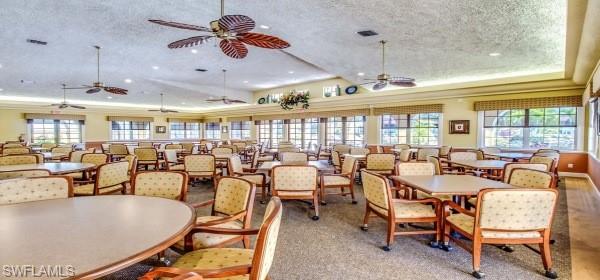 10274 Cape Roman Road, Unit 102 Estero, FL 34135 - Photo 32 of 36 a room with lots of tables a large window and chairs