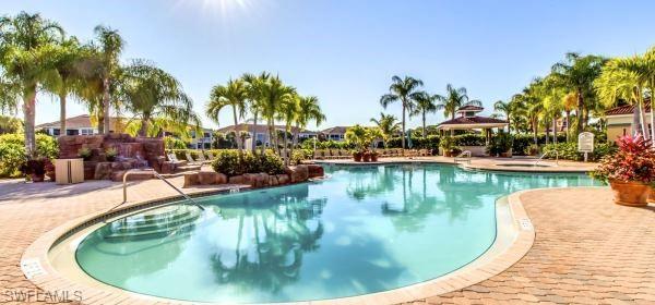 10274 Cape Roman Road, Unit 102 Estero, FL 34135 - Photo 35 of 36 a view of a swimming pool with a sitting space