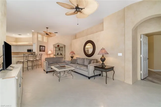 a living room with furniture a rug and white walls