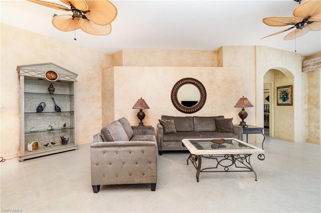 10274 Cape Roman Road, Unit 102 Estero, FL 34135 - Photo 6 of 36 a living room with furniture a mirror and a window