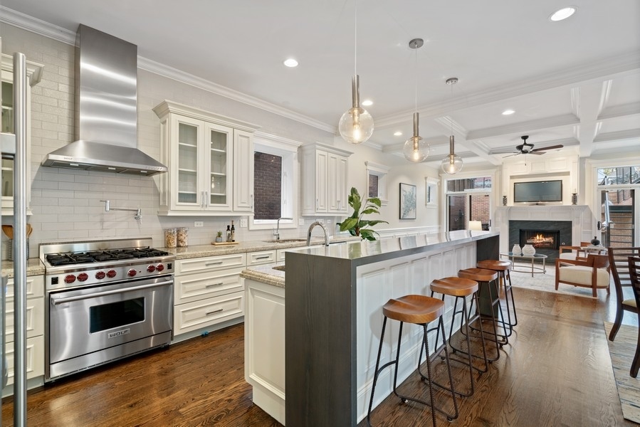 1904 West Wolfram Street Chicago, IL 60657 - Photo 12 of 56 a kitchen with stainless steel appliances a stove a sink a oven a dining table and chairs