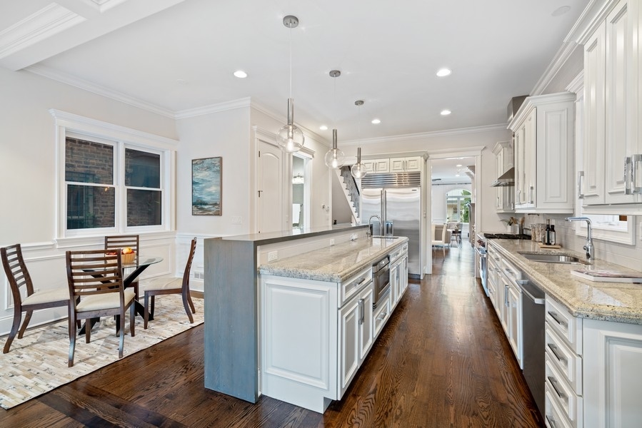 1904 West Wolfram Street Chicago, IL 60657 - Photo 17 of 56 an open kitchen with a table and chairs