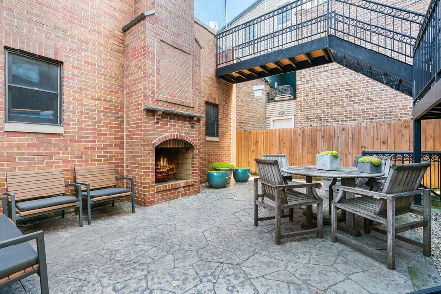 1904 West Wolfram Street Chicago, IL 60657 - Photo 26 of 56 a backyard of a house with barbeque oven table and chairs