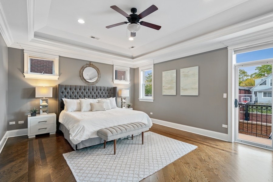 1904 West Wolfram Street Chicago, IL 60657 - Photo 27 of 56 a bedroom with a large bed and a chandelier