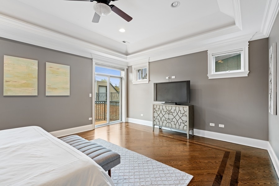 1904 West Wolfram Street Chicago, IL 60657 - Photo 28 of 56 a bedroom with a bed and wooden floor